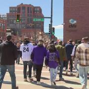 Fans walk along 20th Street in Denver toward Coors Field.