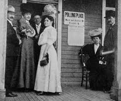 women standing in the doorway of a polling station