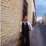 Alan standing against a wall