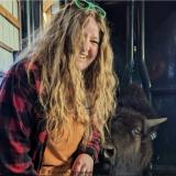 Faye standing with a baby buffalo