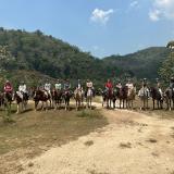Students and teachers on horseback.