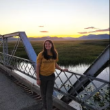 Jessica is standing on a bridge in the wetlands