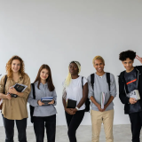 6 very different people standing with books in their hands