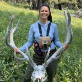 Karina Li holding an elk skull with large antlers