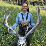 Karina holding the antlers of a large elk