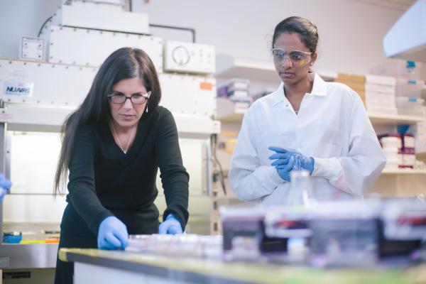 a professor assisting a student in a lab