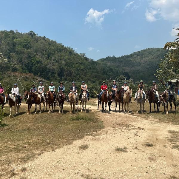 Teachers and students on horseback.