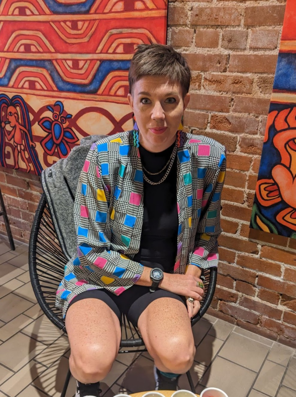 Photo of Emmy Johnson sat in a chair.