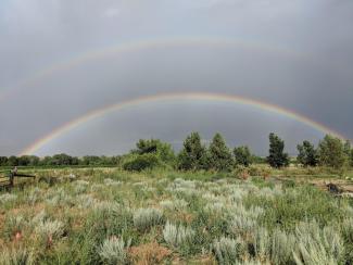 Double rainbow over an open field