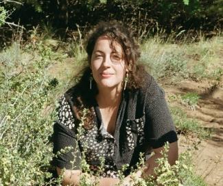 Meredith sitting in a field wearing a black shirt