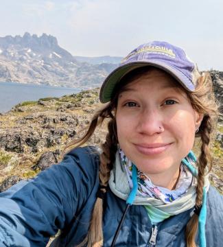 Dani taking a selfie near a mountain lake