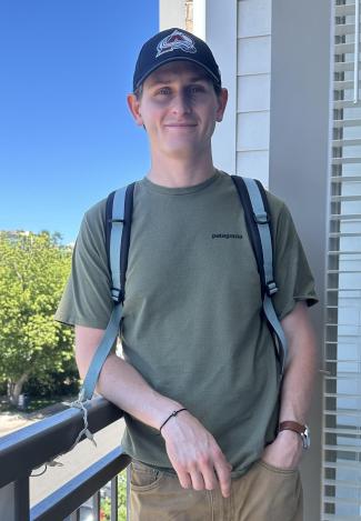 Jacob is standing on a small porch 