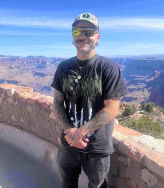 Will is standing on an overlook of a canyon