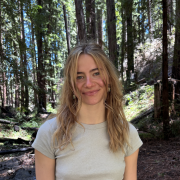 Ashlee wearing a t shirt standing in the forest