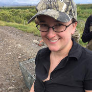Dr. Buderman is holdling a duck while smiling for the camera