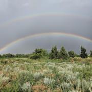 Double rainbow over an open field