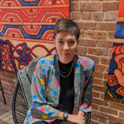 Photo of Emmy Johnson sat in a chair.
