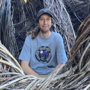 Justin sitting in an extremely large bird's nest