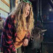 Master's Student Fayelynn Scheideman with a bison. 