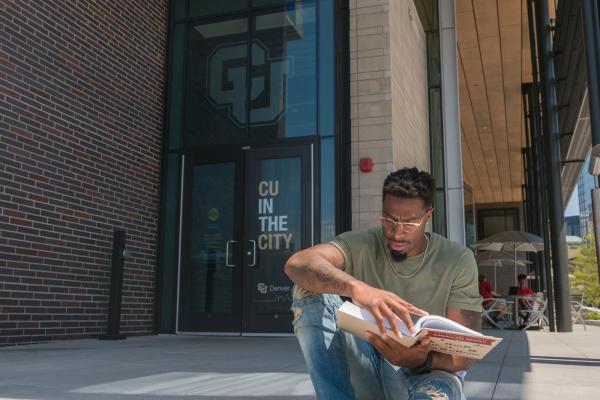 Student Studying in front of Wellness Center