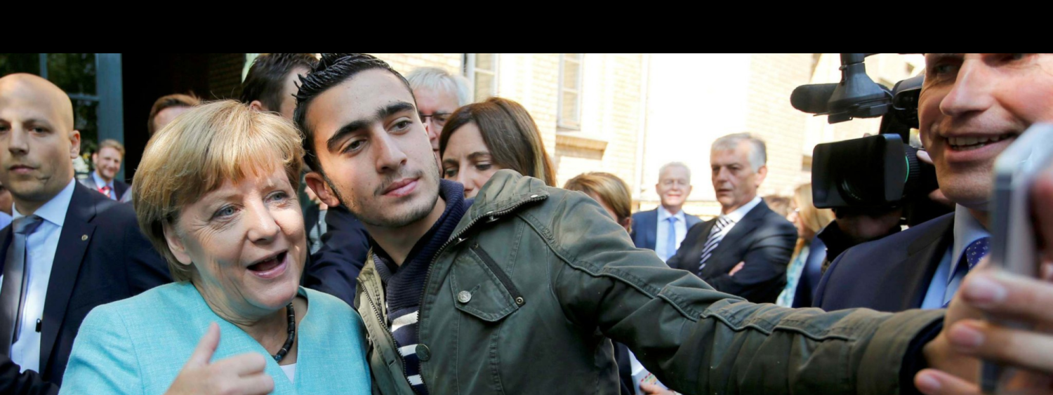 Angela Merkel getting a selfie with a Syrian Refugee
