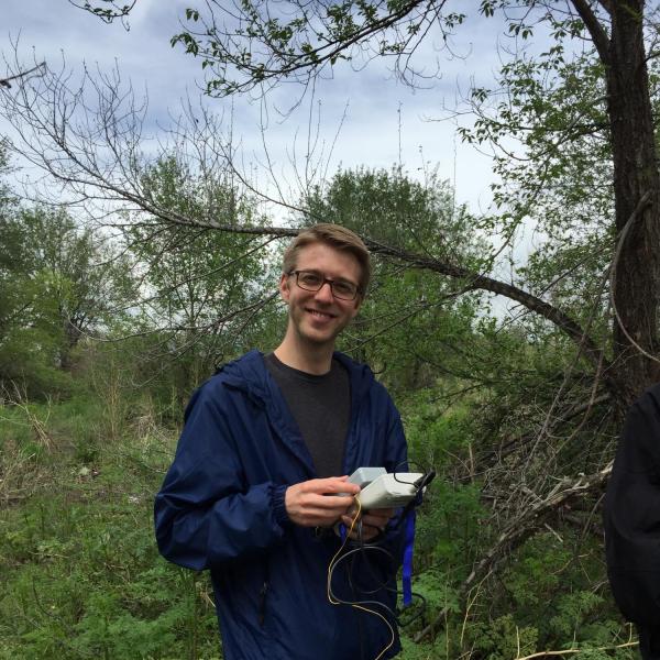 Researcher outside holding equipment