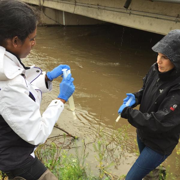 Dr. Mosier with student researcher collecting samples
