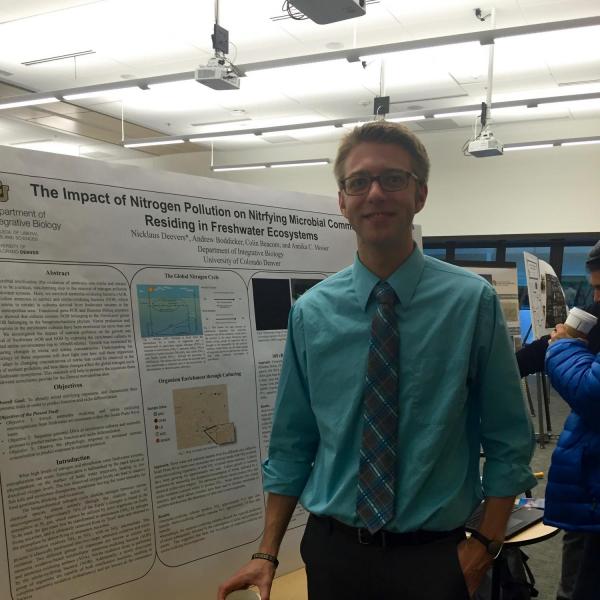 Student researcher presenting research poster