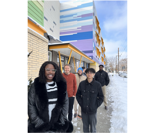 Group of students standing outside colorful building