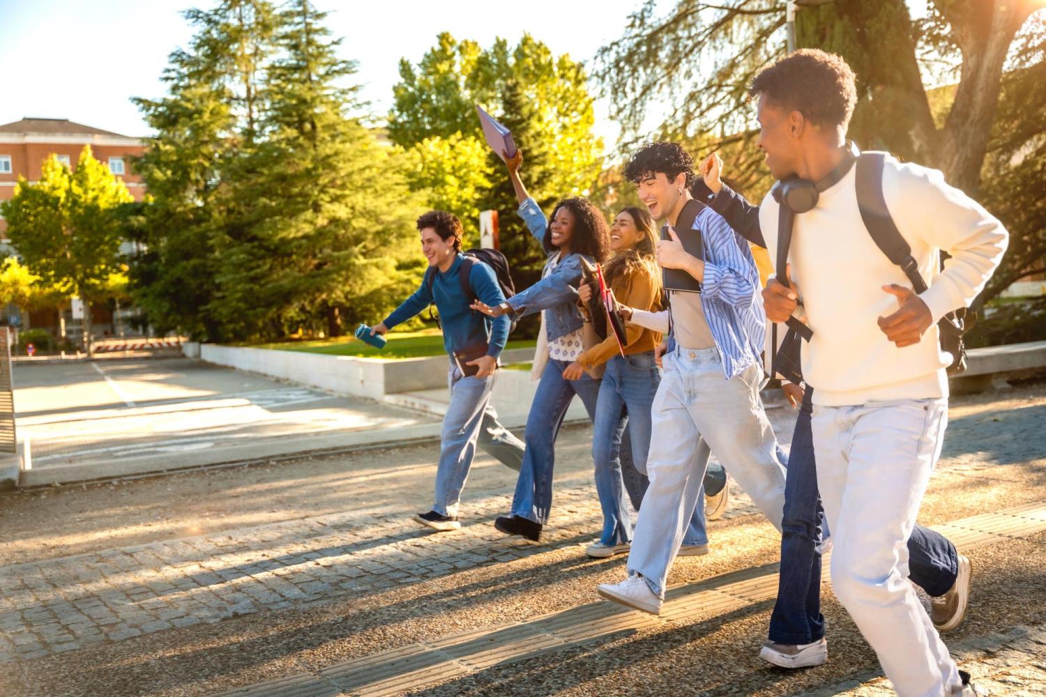 students walk together laughing on college mall