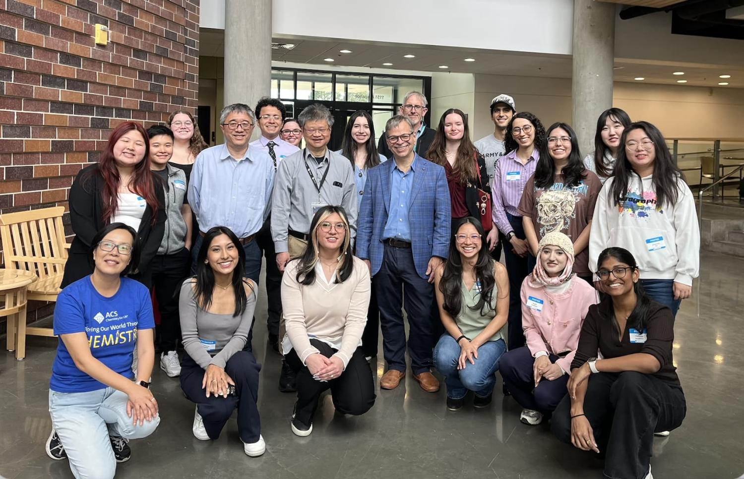 Student presenters, volunteers, and faculty with Prof. Todd Martinez at the student poster session