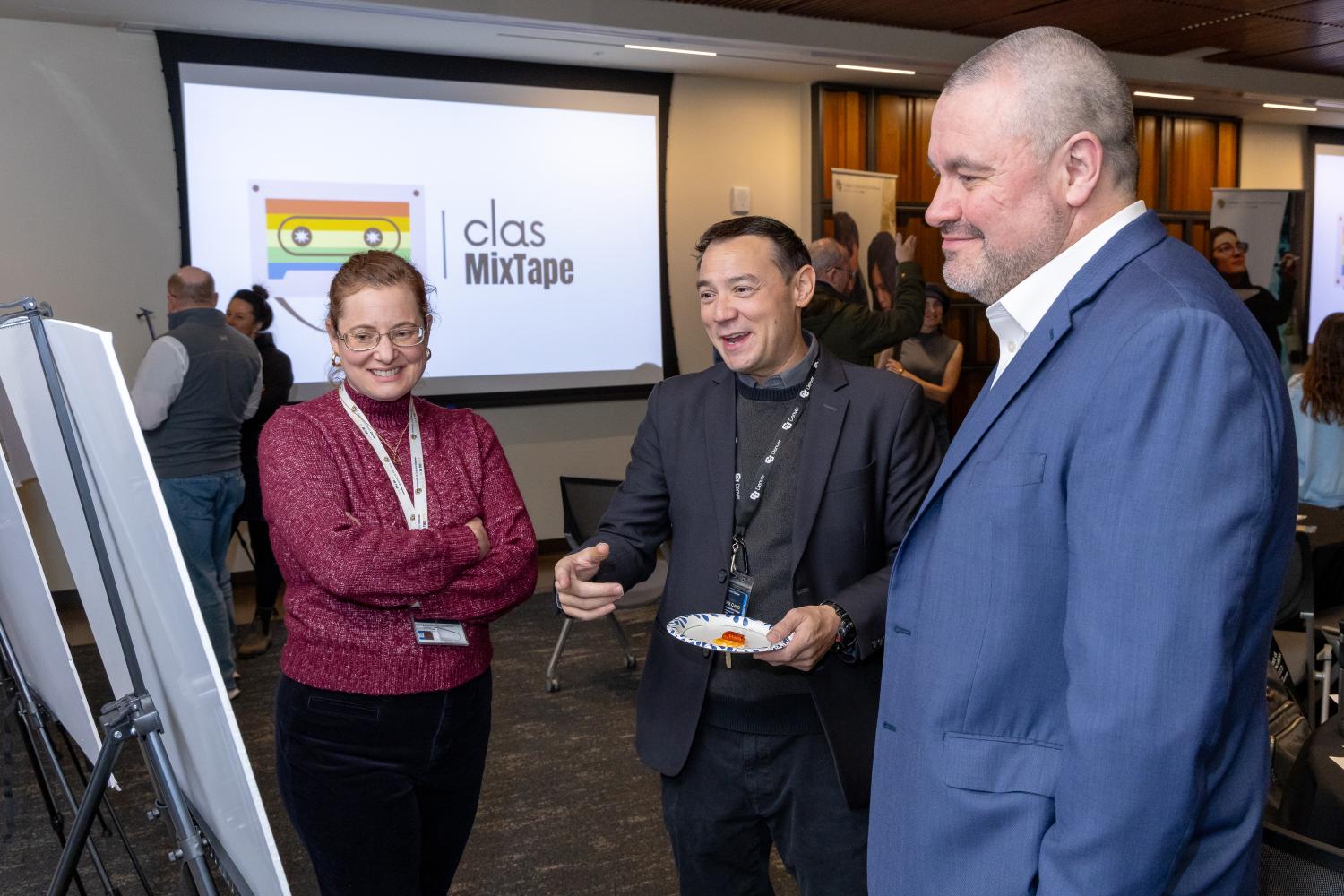 people stand in front of research poster smiling