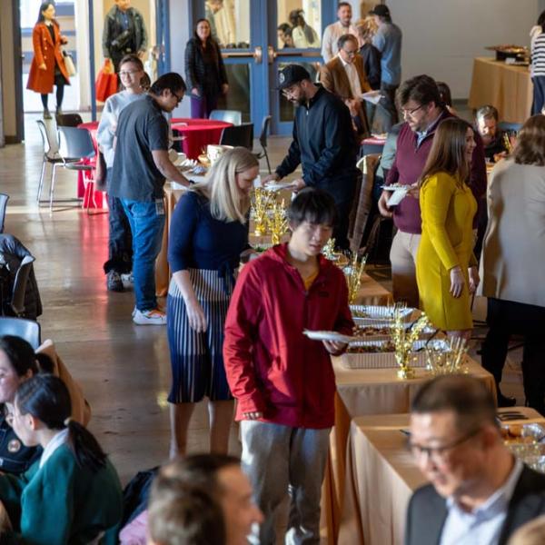 Guests line the food table.