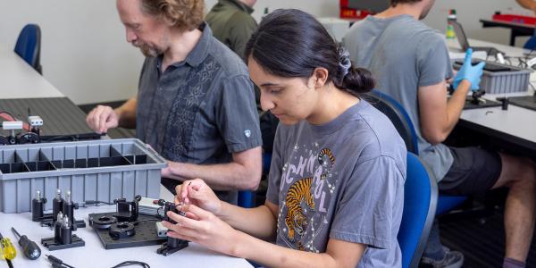 Students in Quantum Information Technology lab work on capstone projects.
