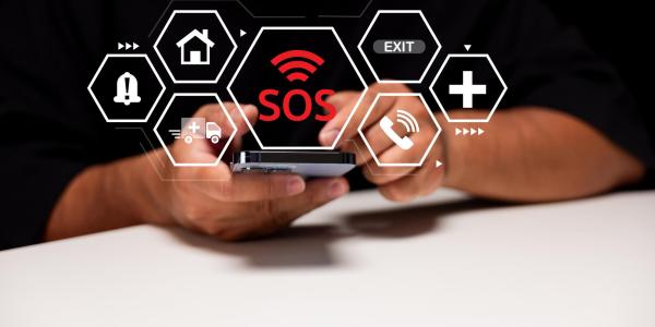 hand holding cell phone with SOS on it