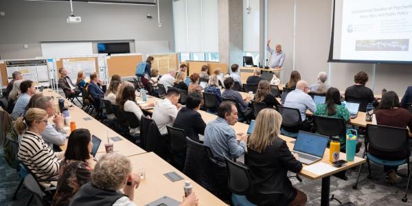 Attendees sit in CU Anschutz classroom listening to Scott Thompson