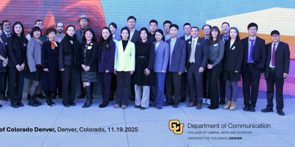 A group of approximately 30 visiting scholars and administrators from U.S. and Chinese universities stand together in front of a colorful mural at the University of Colorado Denver. They are posed in a single row, dressed in professional attire, smiling toward the camera. The CU Denver and Department of Communication logos appear at the bottom of the image along with the event location and date.