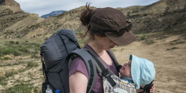 mother holds child in the mountains