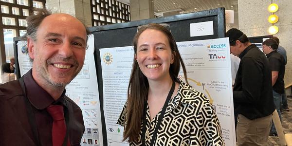 selfie taken by Langou with Hamilton on the side during poster session, we see Hamilton's poster in the background