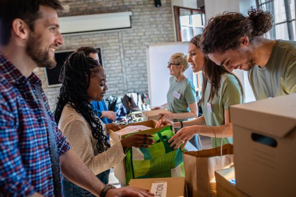 People smile while boxing up donations