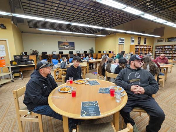 high school students sit with parents