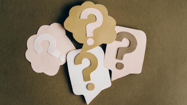 Cardboard question boxes representing uncertainty