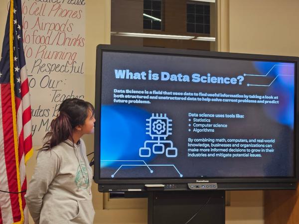 high school students give data science presentation