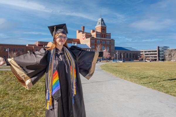 Jami Helmig in front of Tivoli in graduation gown