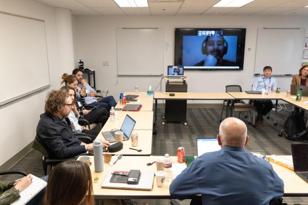 Anthropologists sit around a conference table and talk