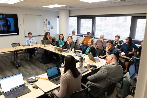Anthropologists sit around a conference table and talk