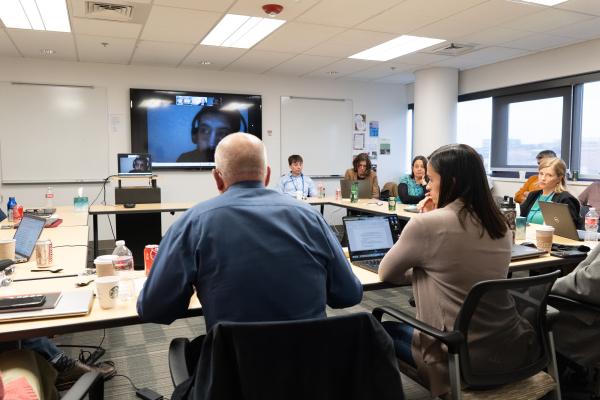 Anthropologists sit around a conference table and talk