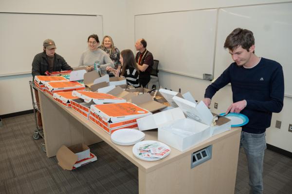students gather around pie table