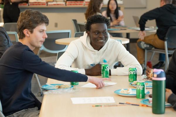student smiles at table