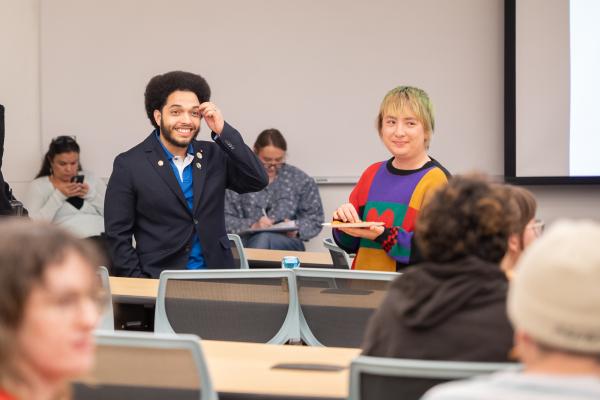 Government officials and students smile for camera